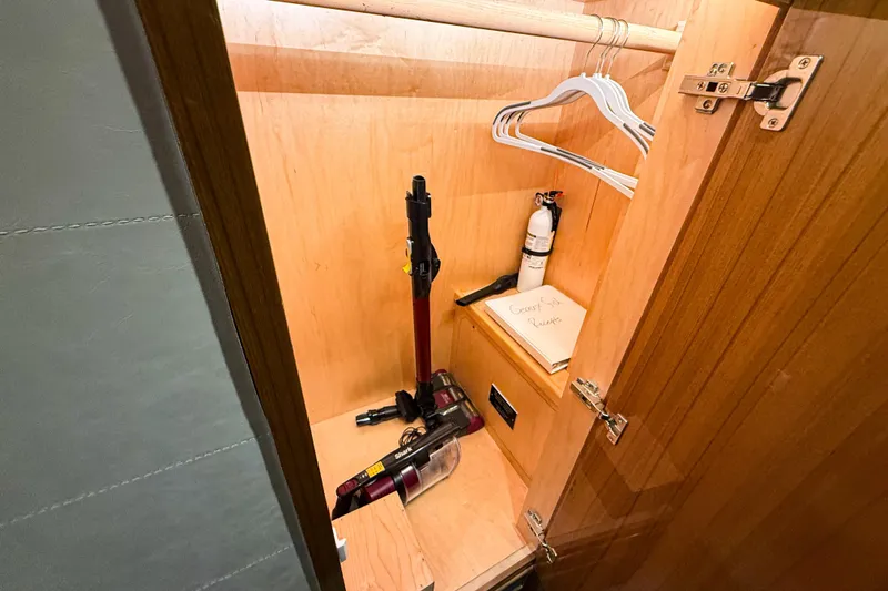  Yacht Photos Pics Wooden closet in 2021 Viking 44 Open yacht with hangers, vacuum, and fire extinguisher.