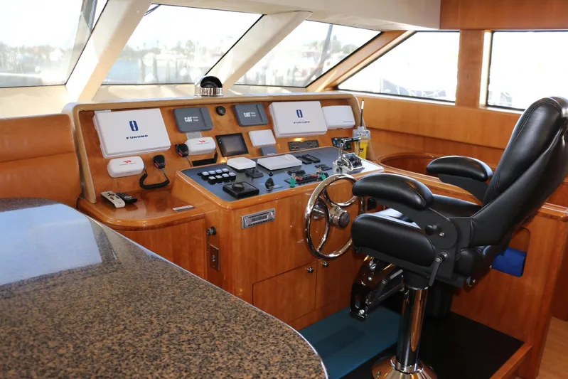  Yacht Photos Pics Helm of 2004 Cheoy Lee 68 yacht with leather chair and navigation controls.