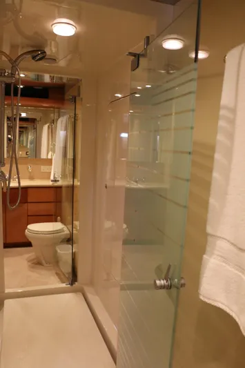 Yacht Photos Pics Luxurious bathroom in 2004 Cheoy Lee 68 yacht with glass shower and modern fixtures.