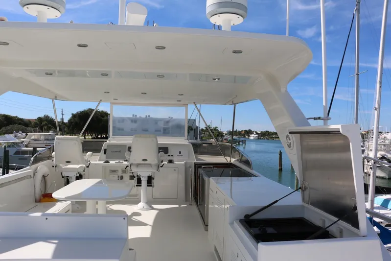  Yacht Photos Pics Luxurious 2004 Cheoy Lee 68 yacht interior with modern amenities and scenic marina view.