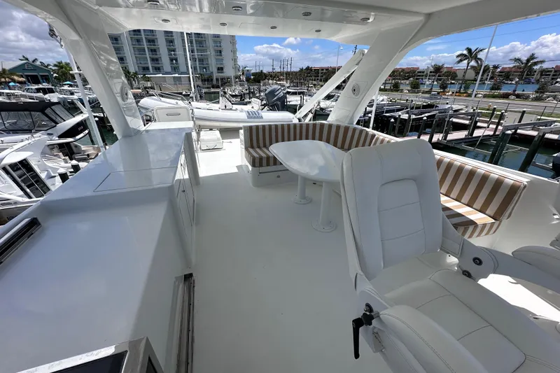  Yacht Photos Pics Luxurious 2004 Cheoy Lee 68 yacht deck with seating and marina view.