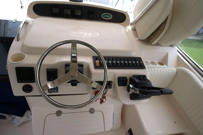  Yacht Photos Pics 2007 Grady-White Express 330 helm with steering wheel and control panel.