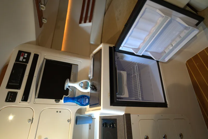  Yacht Photos Pics Interior of 2007 Grady-White Express 330 with open fridge and storage cabinets.