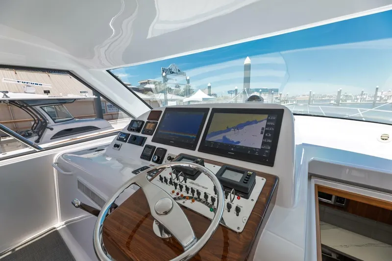 Reely Yacht Photos Pics 2018 Hatteras GT45X Flybridge helm with navigation screens and controls.