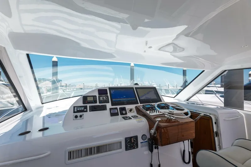 Reely Yacht Photos Pics 2018 Hatteras GT45X Flybridge helm with modern navigation equipment and panoramic marina view.