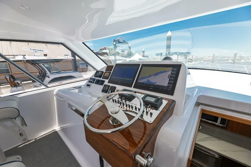 Reely Yacht Photos Pics 2018 Hatteras GT45X Flybridge helm with navigation screens and controls.