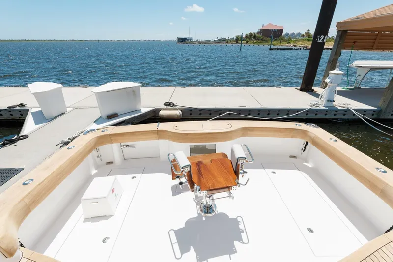 Reely Yacht Photos Pics 2018 Hatteras GT45X Flybridge at dock, featuring spacious cockpit and scenic waterfront view.