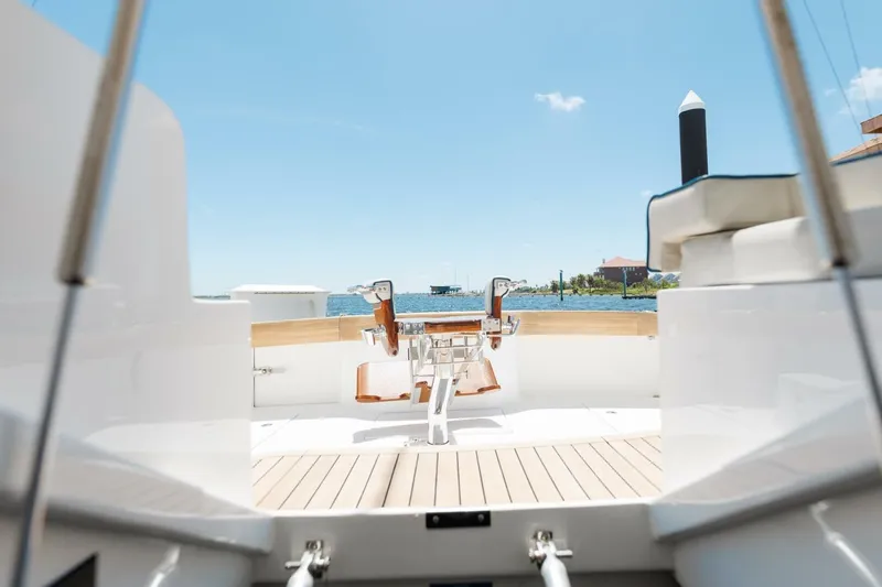 Reely Yacht Photos Pics 2018 Hatteras GT45X Flybridge yacht deck with ocean view and fishing chair.