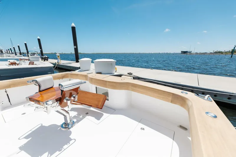 Reely Yacht Photos Pics 2018 Hatteras GT45X Flybridge at dock, featuring a fishing chair and ocean view.