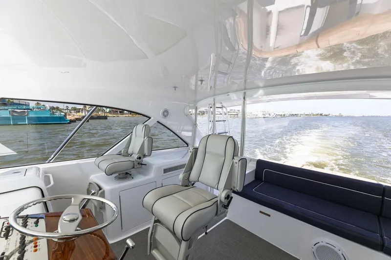 Reely Yacht Photos Pics 2018 Hatteras GT45X Flybridge interior with helm seats and ocean view.