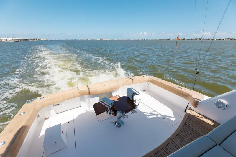 Reely Yacht Photos Pics 2018 Hatteras GT45X Flybridge yacht cruising on open water, showcasing spacious deck.