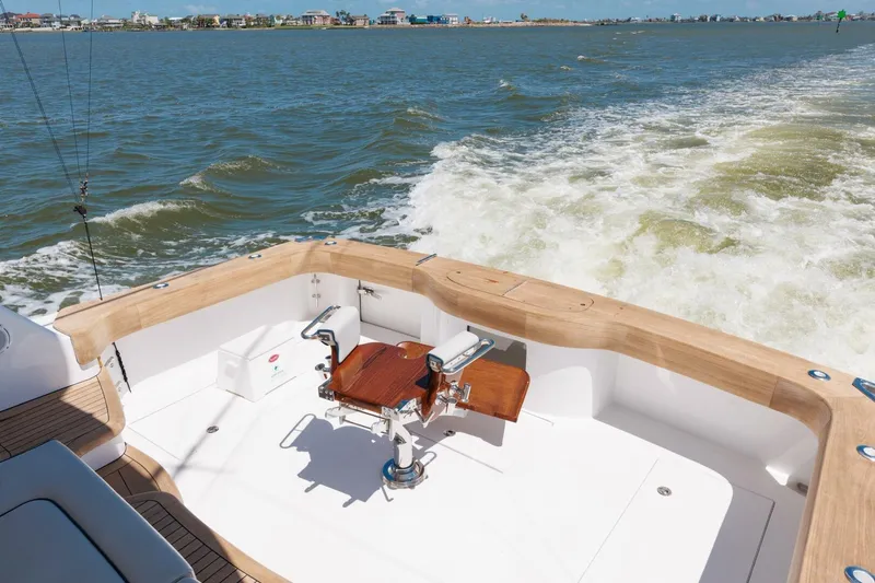Reely Yacht Photos Pics 2018 Hatteras GT45X Flybridge yacht's deck with ocean view and fishing chair.
