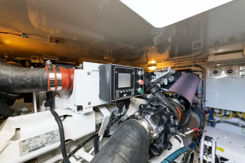 Reely Yacht Photos Pics Engine room of 2018 Hatteras GT45X Flybridge, showcasing mechanical components and control panel.