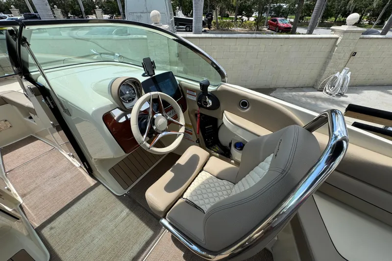  Yacht Photos Pics 2023 Chris-Craft Launch 25 GT boat interior with steering wheel and dashboard controls.