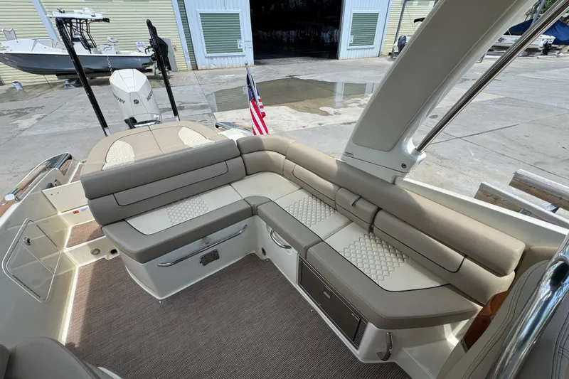  Yacht Photos Pics 2023 Chris-Craft Launch 25 GT boat interior with beige seating and American flag.
