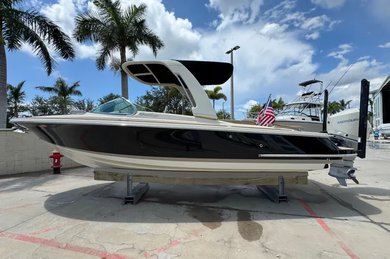  Yacht Photos Pics 2023 Chris-Craft Launch 25 GT boat displayed outdoors with palm trees and blue sky.