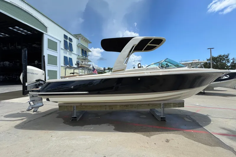  Yacht Photos Pics 2023 Chris-Craft Launch 25 GT boat on display, featuring sleek black and white design.