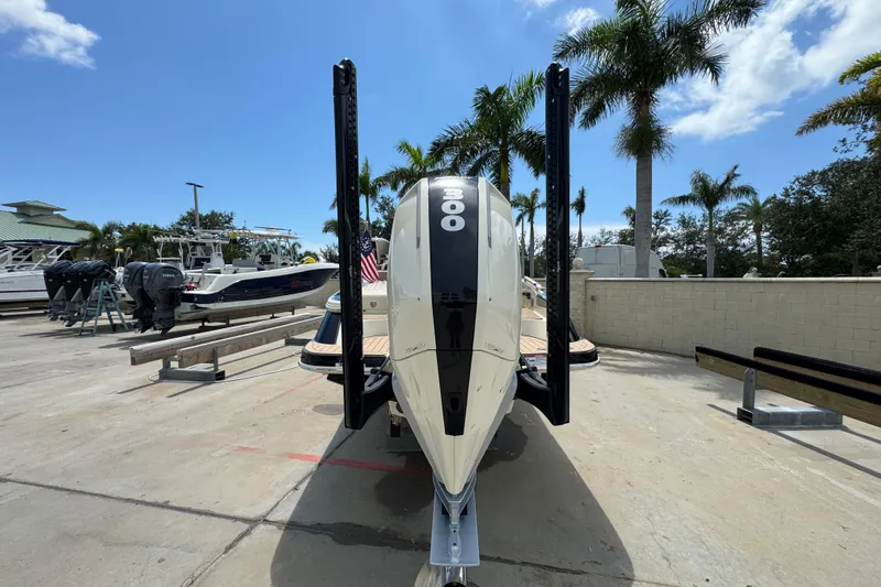  Yacht Photos Pics 2023 Chris-Craft Launch 25 GT boat with powerful engine, docked under clear blue sky.