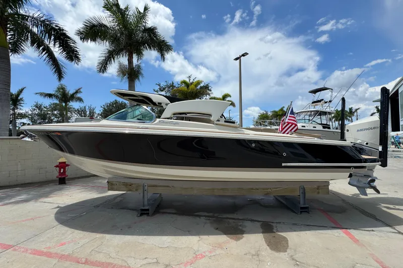  Yacht Photos Pics 2023 Chris-Craft Launch 25 GT boat displayed outdoors with palm trees and blue sky.
