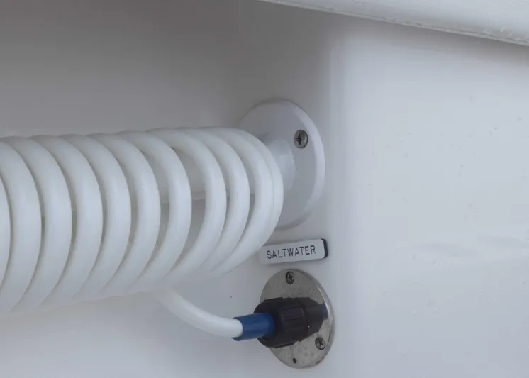  Yacht Photos Pics Coiled hose and saltwater outlet on 2023 Invincible 33 Catamaran.