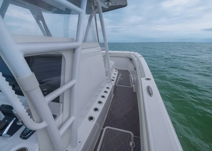  Yacht Photos Pics 2023 Invincible 33 Catamaran on open water, showcasing sleek deck design and ocean view.