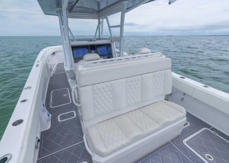  Yacht Photos Pics 2023 Invincible 33 Catamaran with white seating, sleek design, and ocean backdrop.