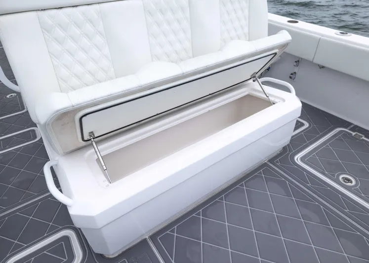  Yacht Photos Pics 2023 Invincible 33 Catamaran with open storage compartment on deck, featuring quilted seating.
