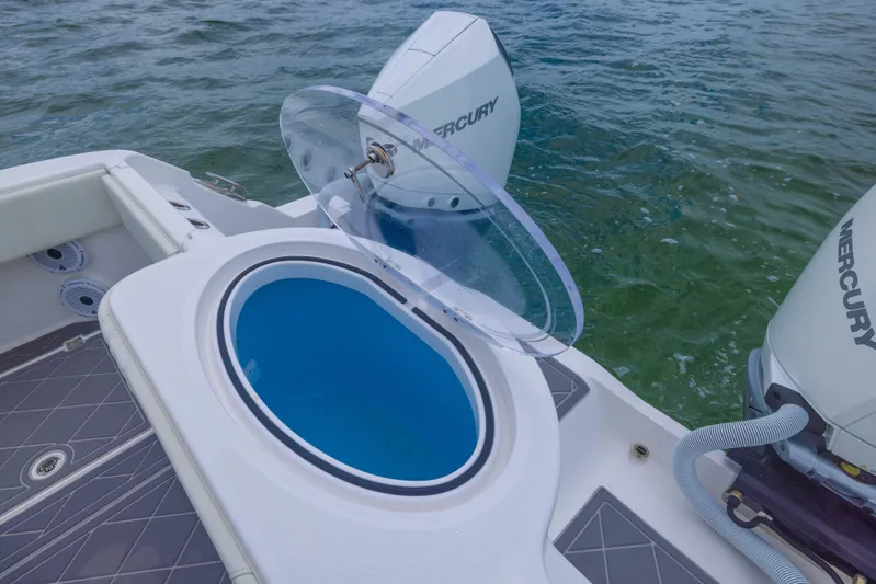  Yacht Photos Pics 2023 Invincible 33 Catamaran with open livewell and Mercury outboard engines on water.