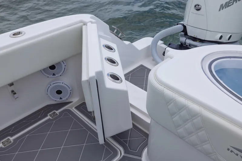  Yacht Photos Pics 2023 Invincible 33 Catamaran boat interior with seating, speakers, and motor detail.