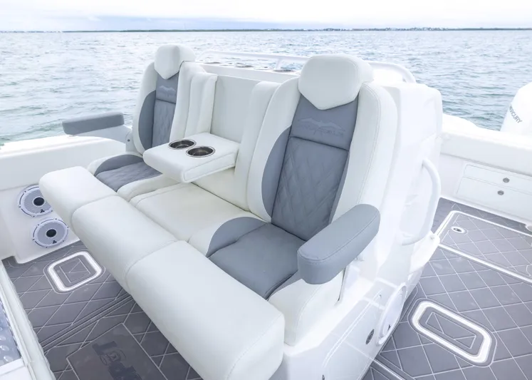  Yacht Photos Pics Luxury seating on 2023 Invincible 33 Catamaran, featuring comfortable armrests and cup holders.