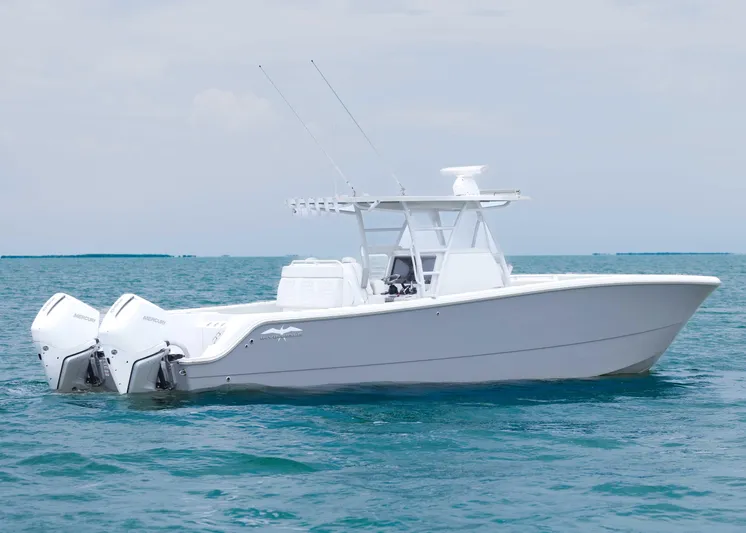  Yacht Photos Pics 2023 Invincible 33 Catamaran on calm ocean waters, showcasing sleek design and twin engines.