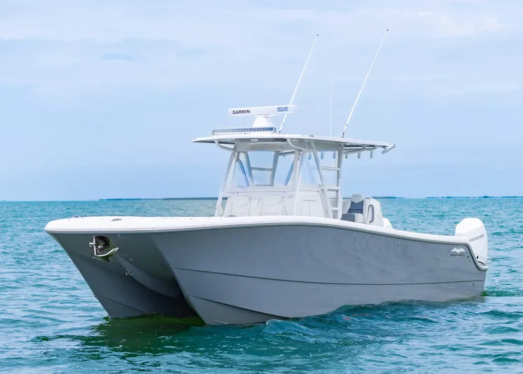  Yacht Photos Pics 2023 Invincible 33 Catamaran on calm ocean waters, showcasing sleek design and modern features.