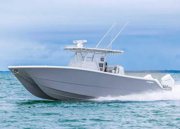  Yacht Photos Pics 2023 Invincible 33 Catamaran cruising on open water, showcasing sleek design and powerful performance.