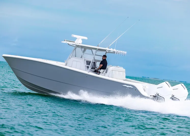  Yacht Photos Pics 2023 Invincible 33 Catamaran speeding on ocean, showcasing sleek design and powerful performance.