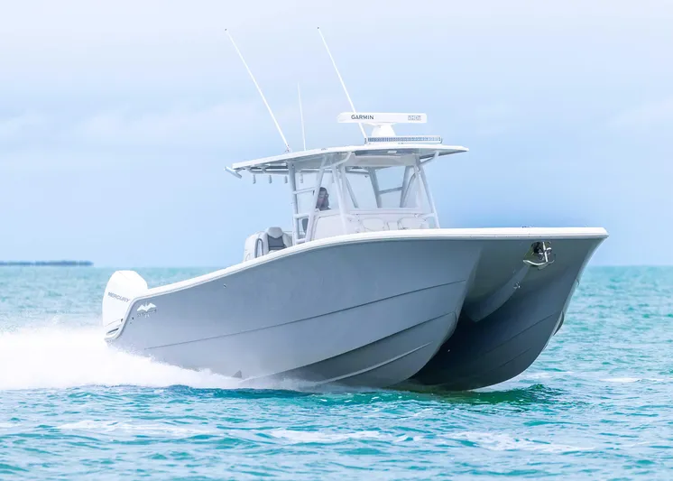  Yacht Photos Pics 2023 Invincible 33 Catamaran cruising on open water, showcasing sleek design and performance.