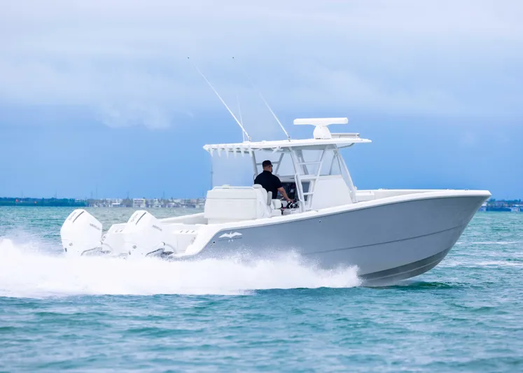  Yacht Photos Pics 2023 Invincible 33 Catamaran cruising on open water, showcasing sleek design and powerful engines.