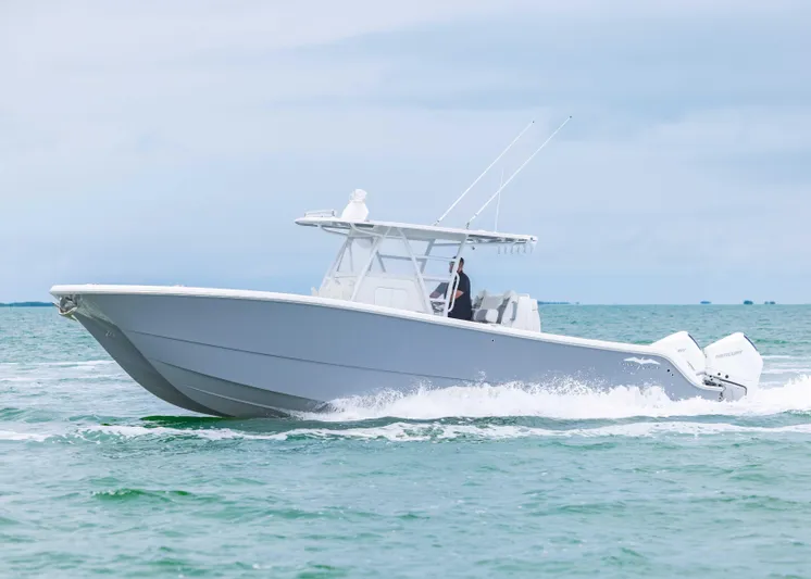  Yacht Photos Pics 2023 Invincible 33 Catamaran cruising on open water, showcasing sleek design and powerful engines.