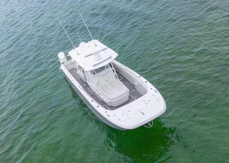  Yacht Photos Pics 2023 Invincible 33 Catamaran on clear green water, aerial view.