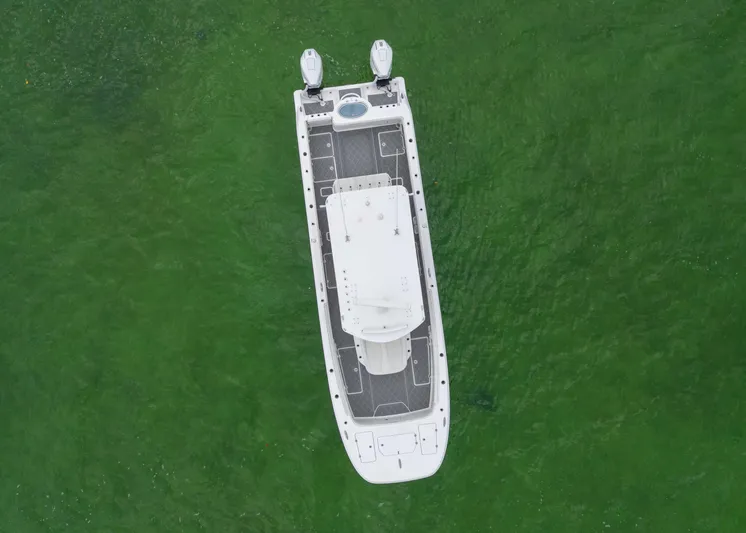  Yacht Photos Pics Aerial view of 2023 Invincible 33 Catamaran on green water.