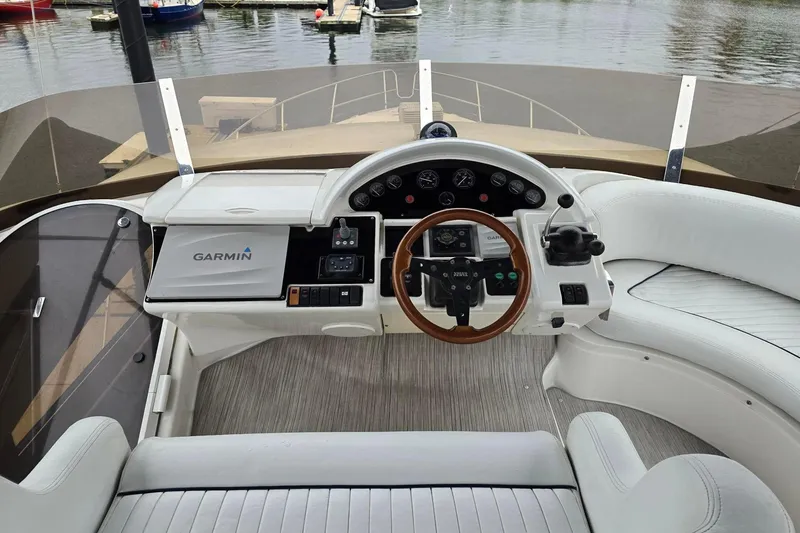  Yacht Photos Pics Cockpit of 1999 Viking Princess 56 yacht with Garmin navigation system and wooden steering wheel.