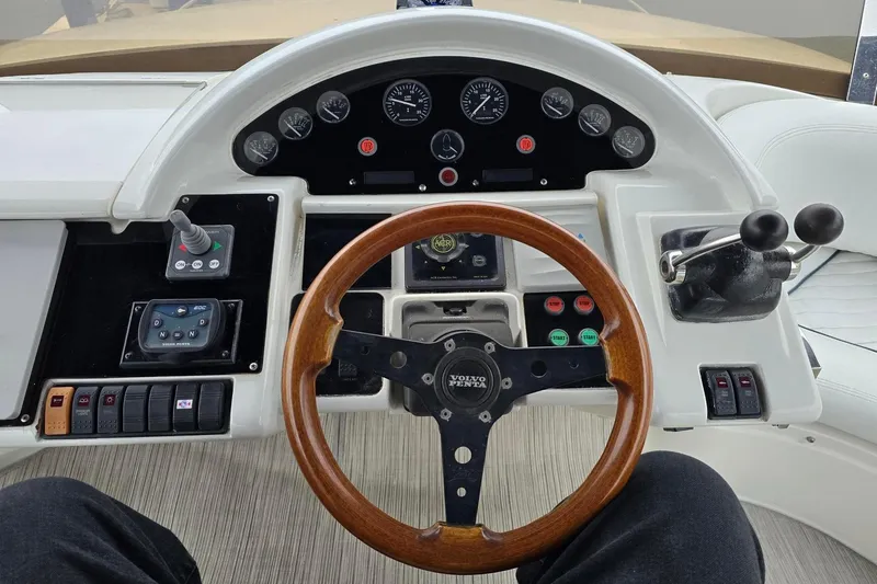  Yacht Photos Pics Cockpit of 1999 Viking Princess 56 yacht with wooden steering wheel and control panel.