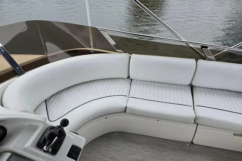  Yacht Photos Pics White seating area on a 1999 Viking Princess 56 yacht, overlooking water.