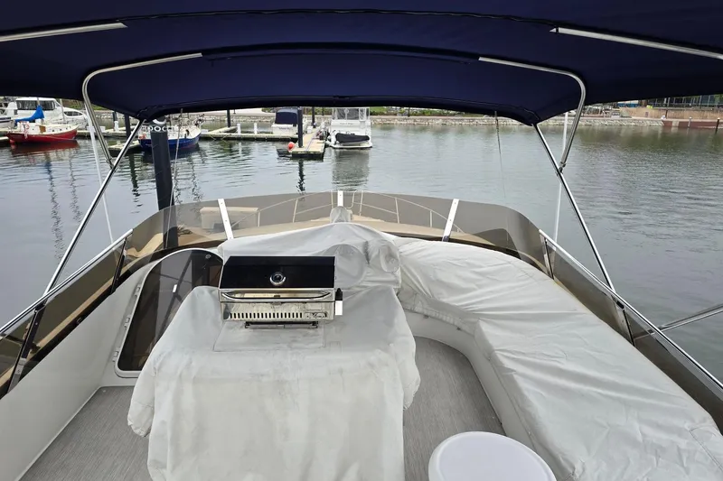  Yacht Photos Pics Luxury Viking Princess 56 yacht deck with covered seating and grill, docked in a marina, 1999 model.