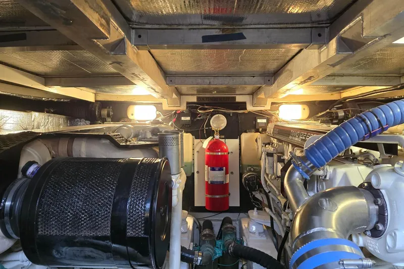  Yacht Photos Pics Engine room of 1999 Viking Princess 56 yacht with visible machinery and fire extinguisher.