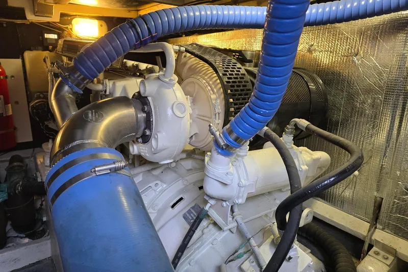  Yacht Photos Pics Engine room of a 1999 Viking Princess 56 yacht with blue hoses and metallic components.