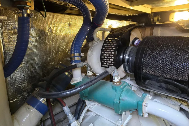  Yacht Photos Pics Engine room of 1999 Viking Princess 56 yacht with visible hoses and components.