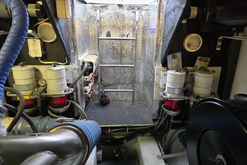  Yacht Photos Pics Engine room of 1999 Viking Princess 56 yacht with mechanical components and ladder.