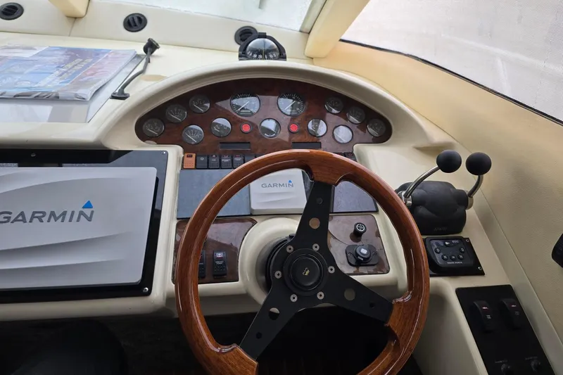  Yacht Photos Pics Cockpit of 1999 Viking Princess 56 yacht with Garmin navigation system and wooden steering wheel.