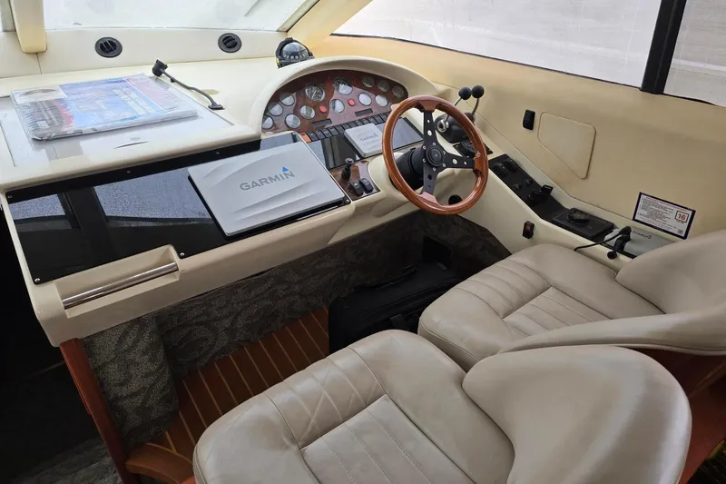  Yacht Photos Pics Cockpit of 1999 Viking Princess 56 yacht with Garmin navigation system and leather seating.