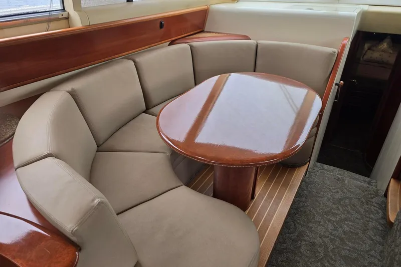 Yacht Photos Pics Luxurious interior of 1999 Viking Princess 56 yacht with elegant seating and polished wood table.